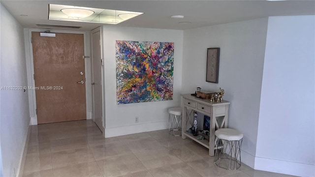 hall featuring light tile patterned flooring