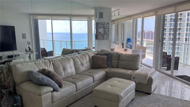 living room featuring expansive windows and a water view