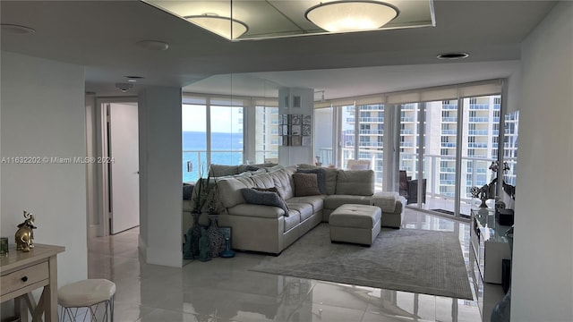 living room with a water view and expansive windows