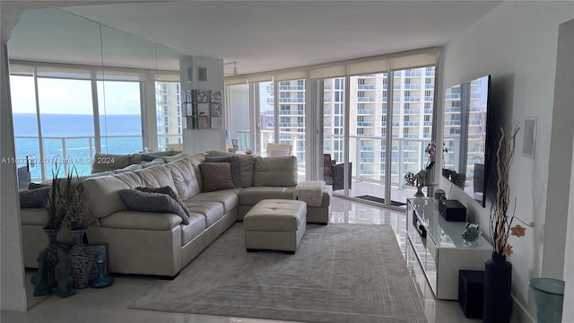 living room featuring a water view, a wall of windows, and a healthy amount of sunlight