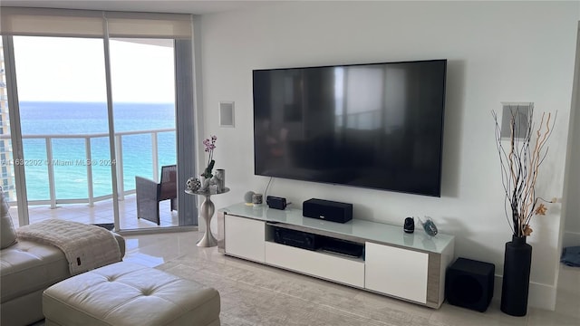 tiled living room featuring floor to ceiling windows