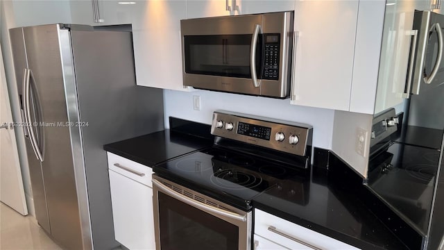 kitchen with stainless steel appliances and white cabinets