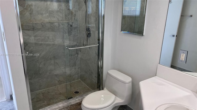 bathroom featuring an enclosed shower, vanity, and toilet