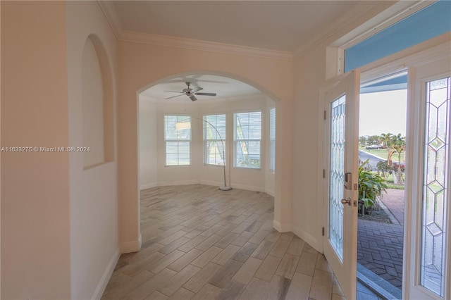 interior space featuring light wood-type flooring, ceiling fan, and crown molding