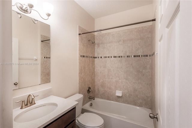 full bathroom featuring toilet, vanity, and tiled shower / bath