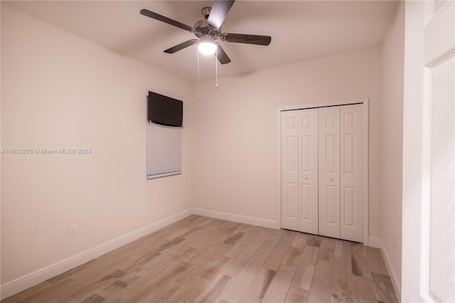 unfurnished bedroom with light wood-type flooring, a closet, and ceiling fan