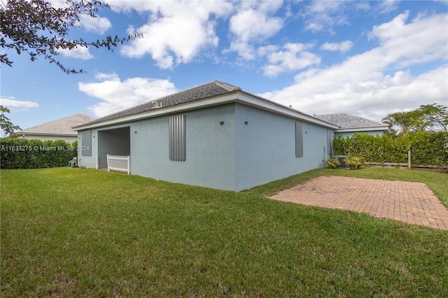 back of property with a patio area and a yard