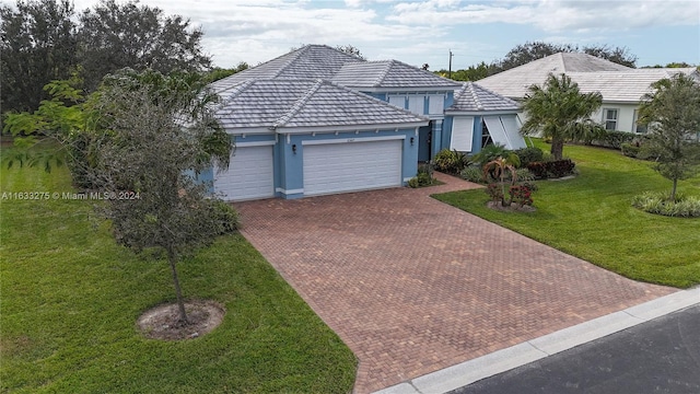 view of front facade with a front yard and a garage