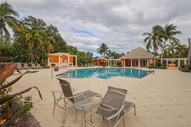 view of pool featuring a patio and an outdoor structure