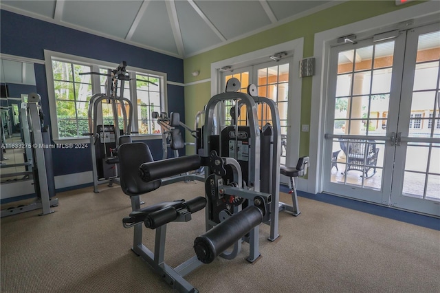 workout area with carpet, vaulted ceiling, and french doors