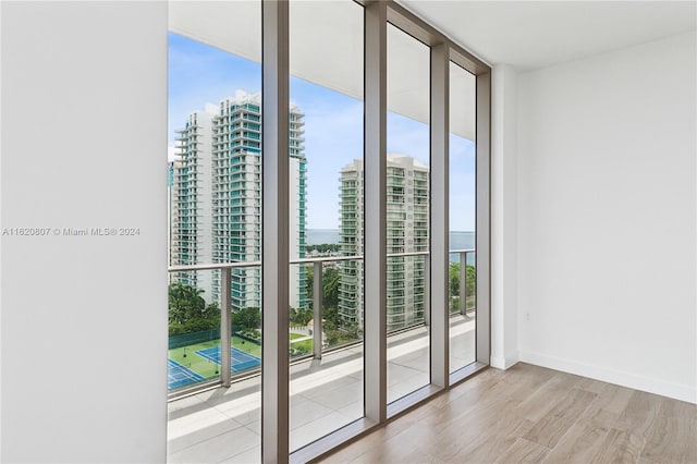 doorway to outside featuring light hardwood / wood-style floors and floor to ceiling windows