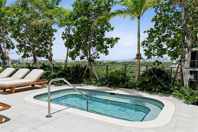 view of swimming pool with an in ground hot tub and a patio area