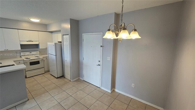 11060 SW 196th St Unit 214, Cutler Bay, FL 33157 - kitchen with light countertops, white cabinets, under cabinet range hood, white appliances, and light tile patterned flooring