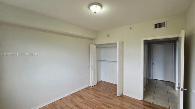 11060 SW 196th St Unit 214, Cutler Bay, FL 33157 - unfurnished bedroom with light wood-style floors, baseboards, and visible vents