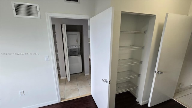 closet with visible vents and stacked washer and clothes dryer