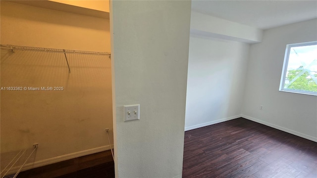 clothes washing area with dark hardwood / wood-style floors