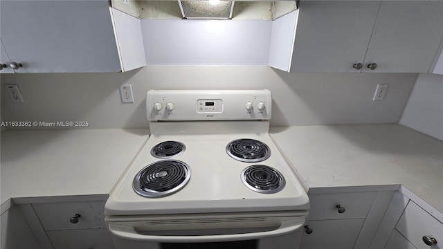 room details featuring gray cabinetry, light countertops, white electric range oven, and extractor fan