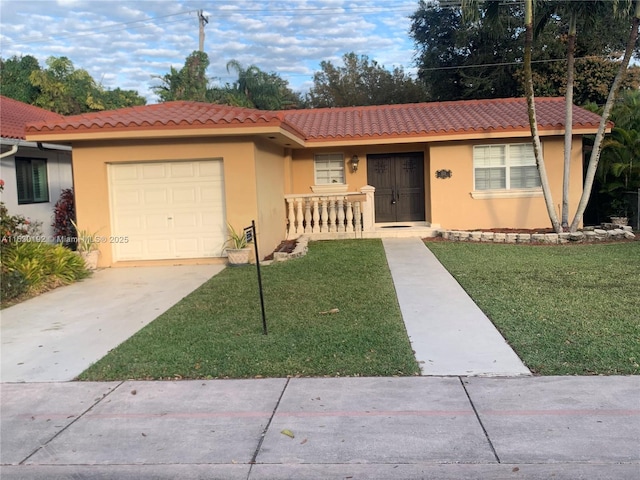 single story home featuring a garage and a front yard