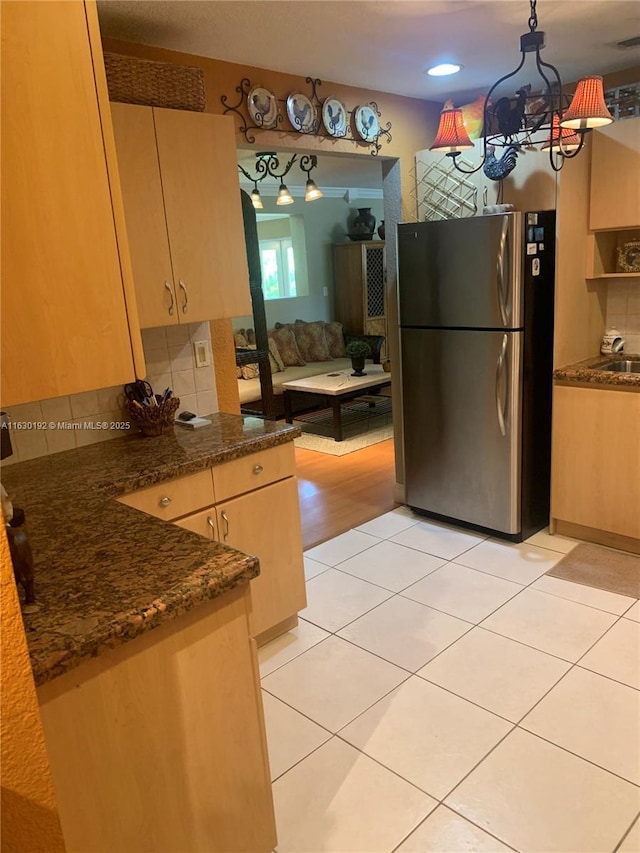 825 El Rado St, Coral Gables, FL 33134 - kitchen with freestanding refrigerator, tasteful backsplash, light tile patterned floors, and light brown cabinets