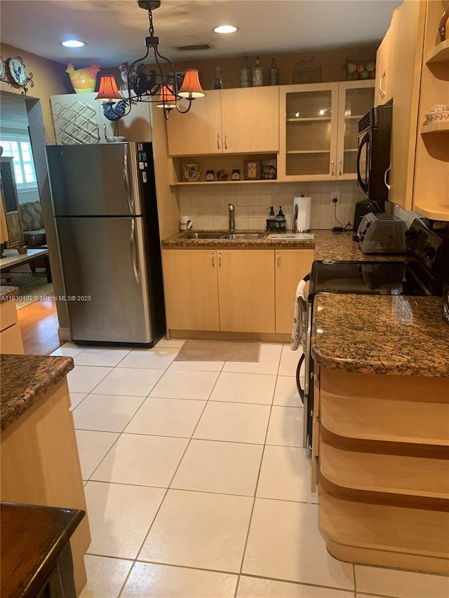 825 El Rado St, Coral Gables, FL 33134 - kitchen with freestanding refrigerator, electric stove, open shelves, black microwave, and backsplash