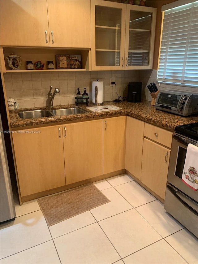 825 El Rado St, Coral Gables, FL 33134 - kitchen with stainless steel range, open shelves, tasteful backsplash, glass insert cabinets, and dark stone counters