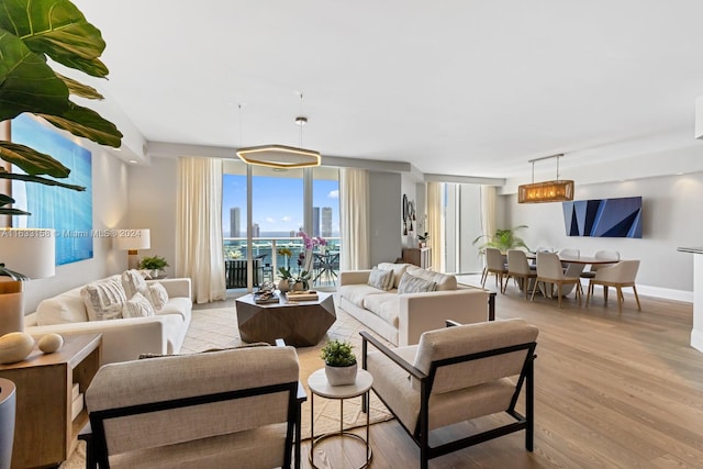 living room featuring light hardwood / wood-style floors and a wall of windows