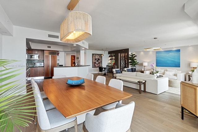 dining space with light wood-type flooring