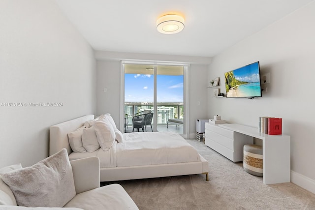 bedroom with access to outside and light carpet