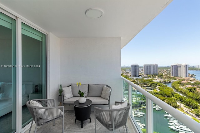 balcony featuring cooling unit, a water view, and an outdoor hangout area