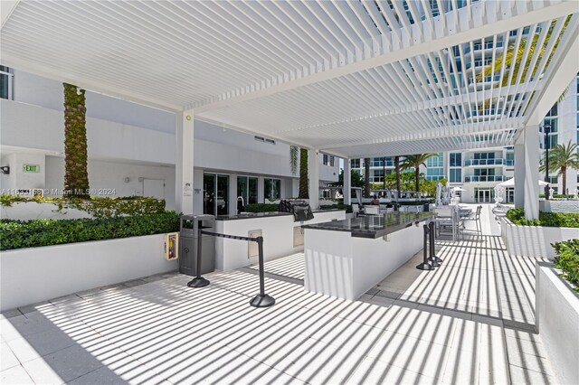 view of patio featuring a bar and area for grilling