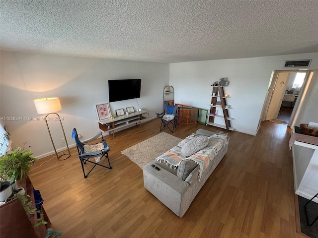 living room featuring a textured ceiling and hardwood / wood-style floors