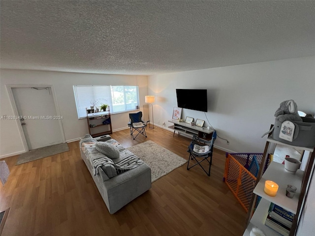 living room with hardwood / wood-style floors and a textured ceiling