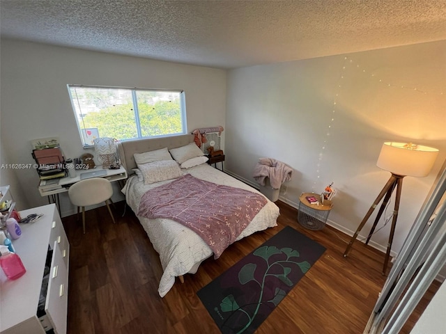 bedroom with wood-type flooring and a textured ceiling