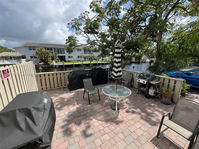 view of patio / terrace with area for grilling and a water view