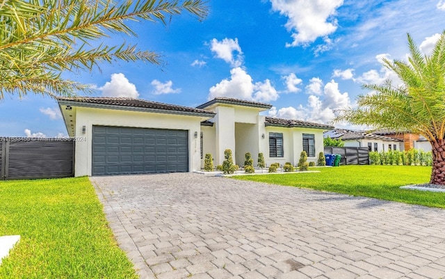 mediterranean / spanish-style home featuring a garage and a front lawn