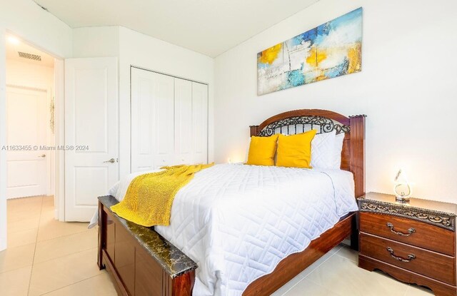 tiled bedroom with a closet