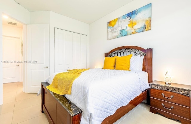 bedroom with a closet and light tile patterned floors