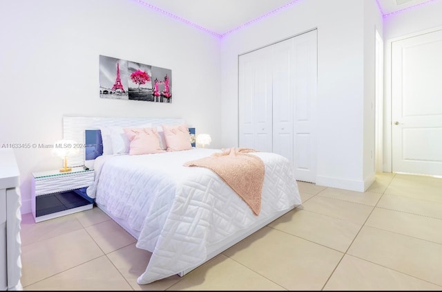 tiled bedroom featuring a closet