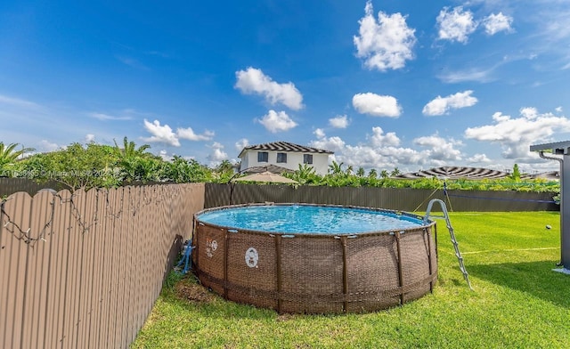 view of swimming pool featuring a yard and a water view