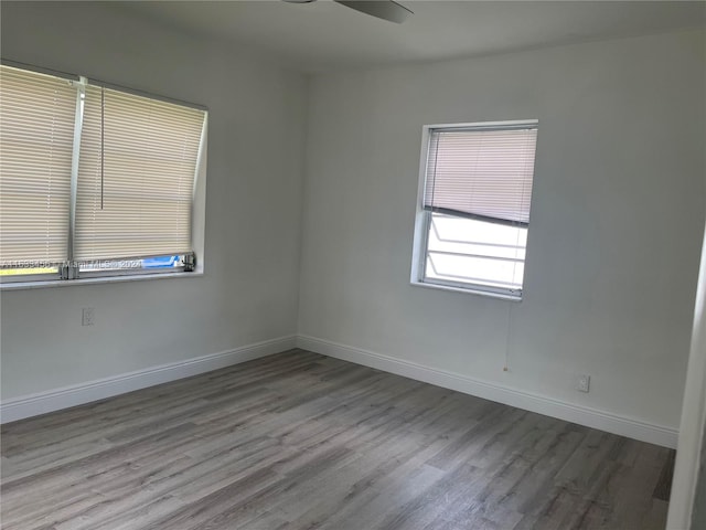 spare room featuring hardwood / wood-style flooring and ceiling fan