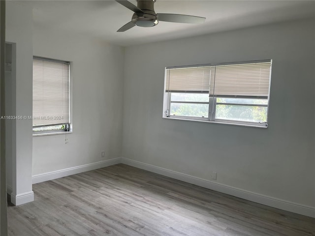 spare room with ceiling fan and hardwood / wood-style flooring