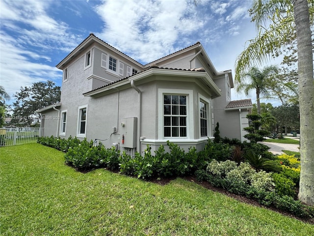 view of side of home featuring a lawn