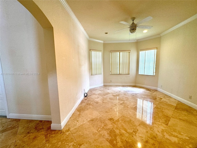 spare room featuring ceiling fan and ornamental molding