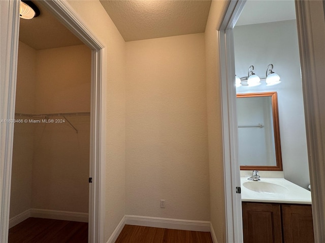 bathroom featuring a textured ceiling, vanity, and hardwood / wood-style flooring