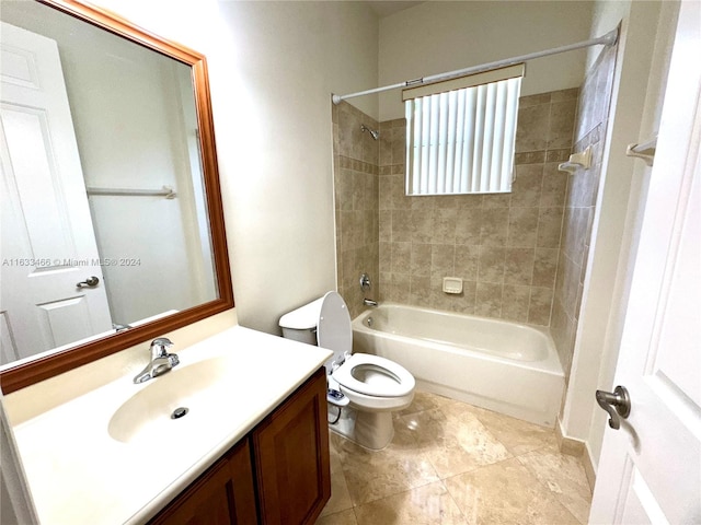 full bathroom featuring tiled shower / bath combo, vanity, and toilet