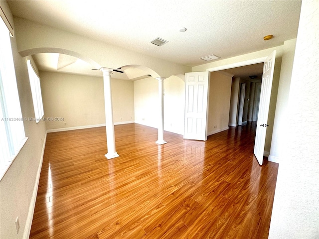 interior space featuring wood-type flooring and a textured ceiling