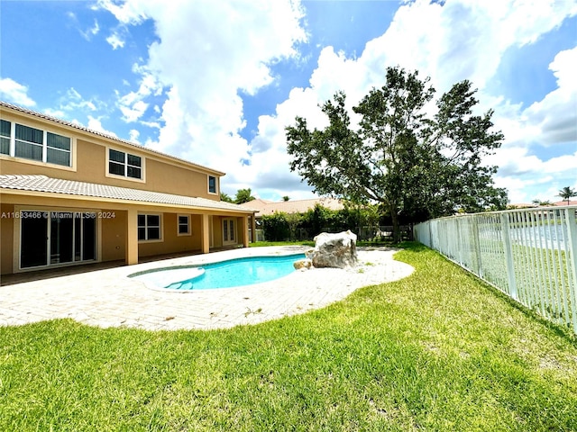 view of pool featuring a lawn and a patio area