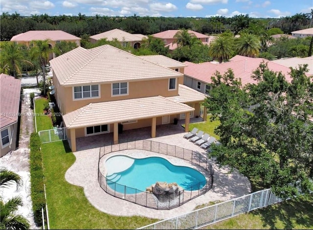 view of pool featuring a lawn and a patio