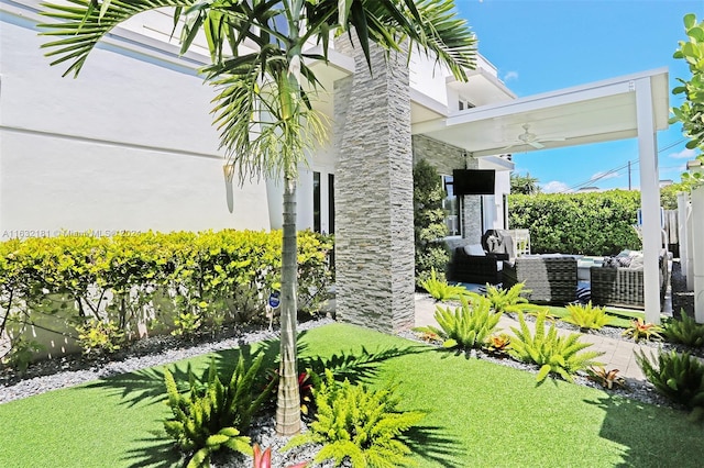 view of yard with an outdoor hangout area and ceiling fan