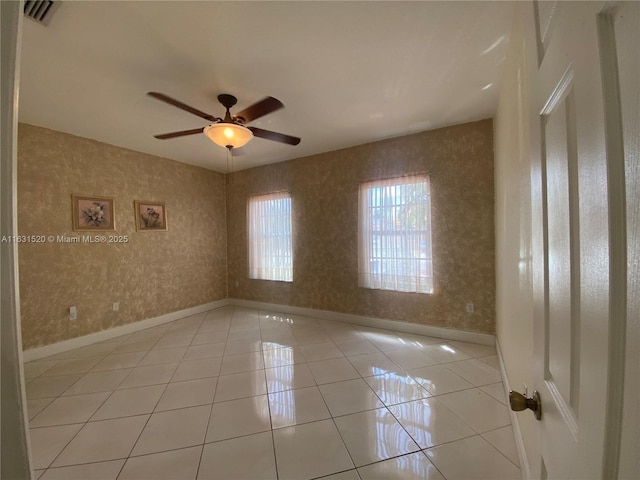 spare room featuring ceiling fan and light tile patterned flooring